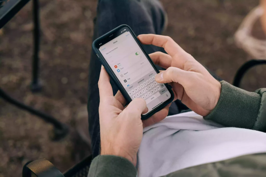 Man adding reminders in his phone so he can set goals and crush them